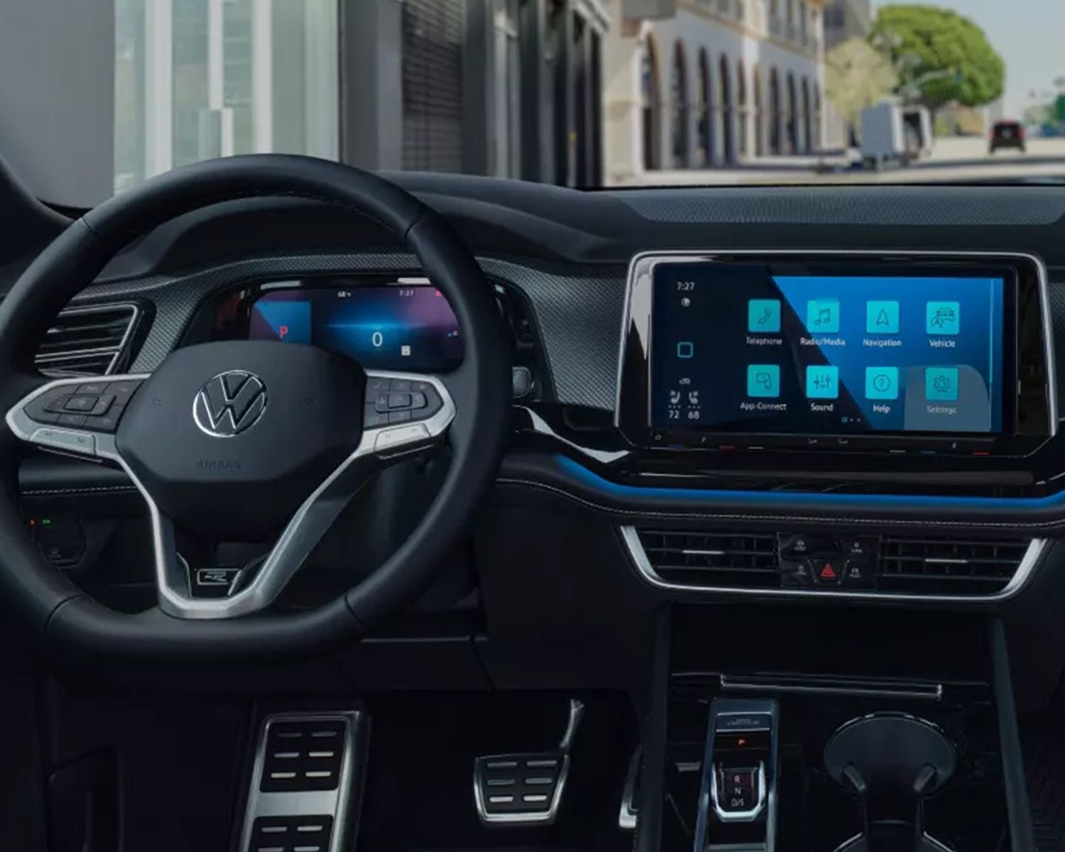 Interior view of a car dashboard with digital displays.